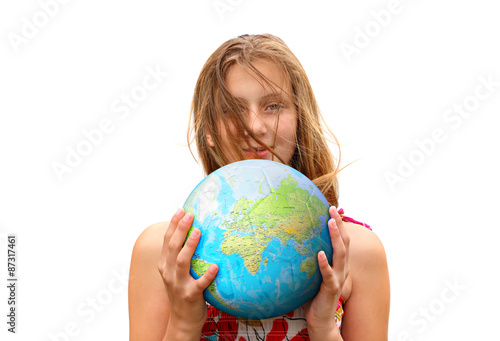 Child dreams about travel / Smiling teenage girl holding a globe ball