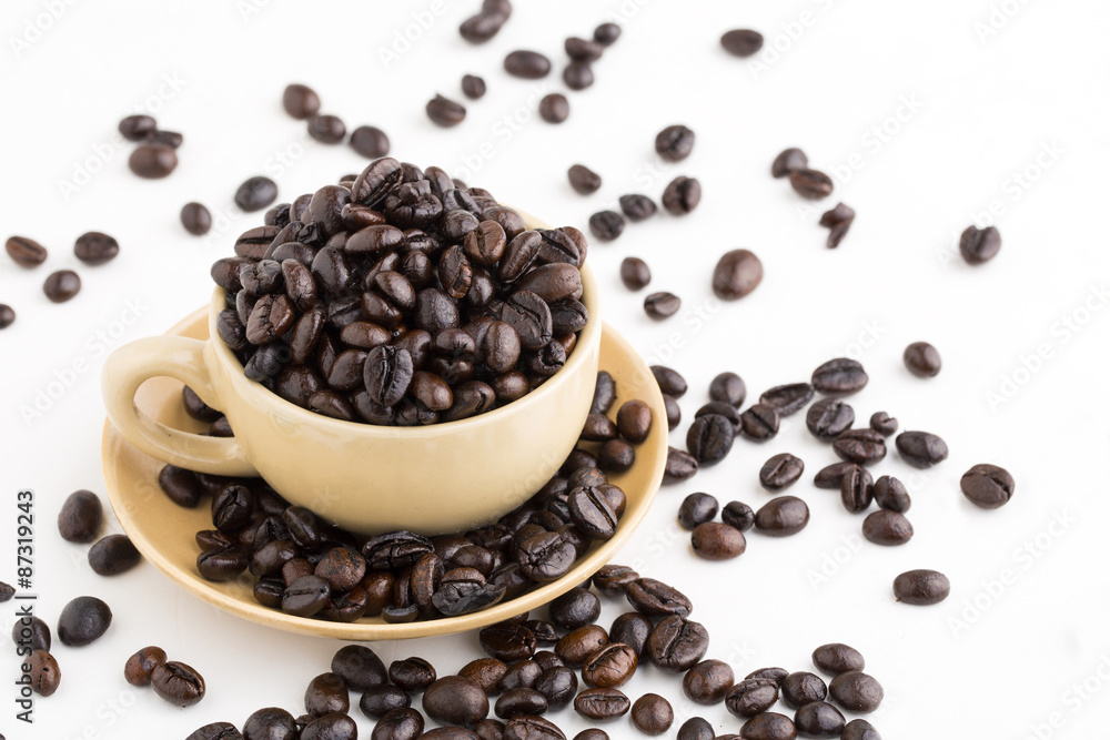 Cup full of coffee beans on on white background Cup full of coffee beans on on white background