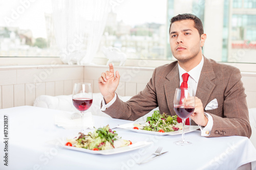 Handsome young businessman has an appointment in restaurant