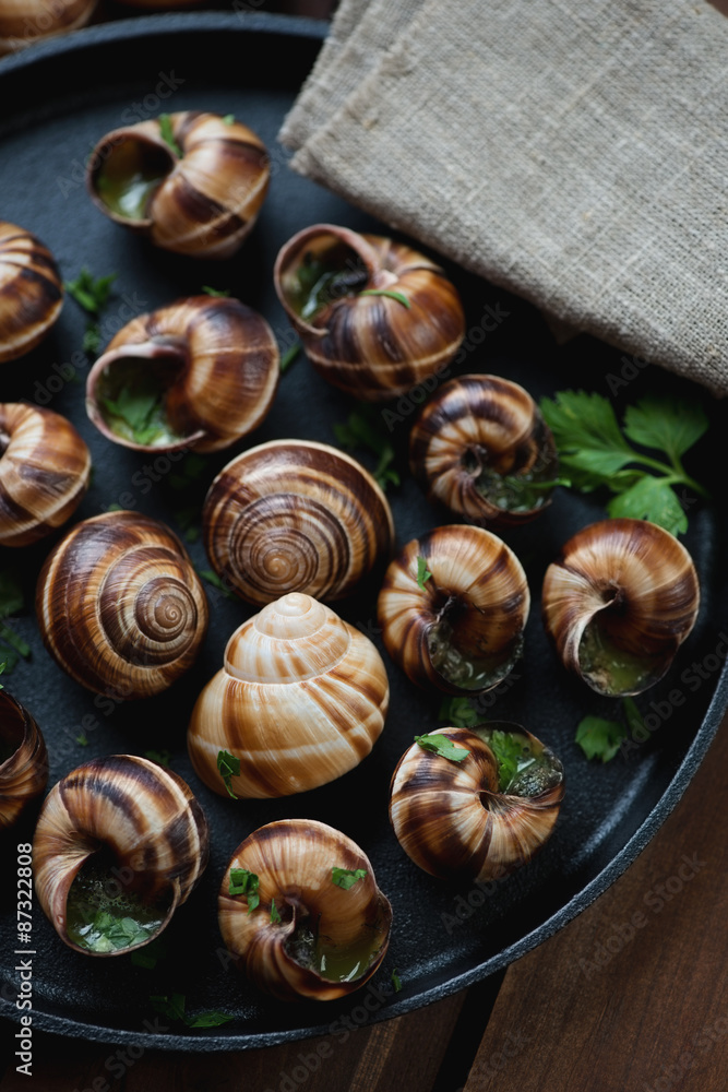 Baked bourgogne snails with garlic butter and parsley, close-up Baked bourgogne snails with garlic butter and parsley, close-up