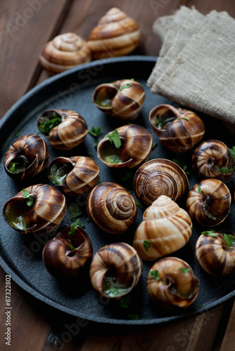 Bourguignonne snail au gratin in a frying pan, close-up