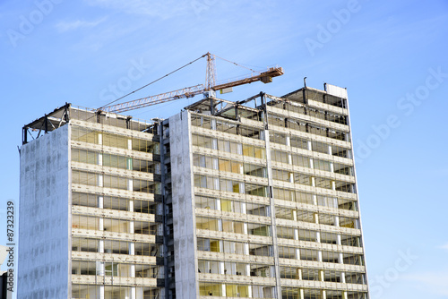 demolition of a skyscraper with a high crane