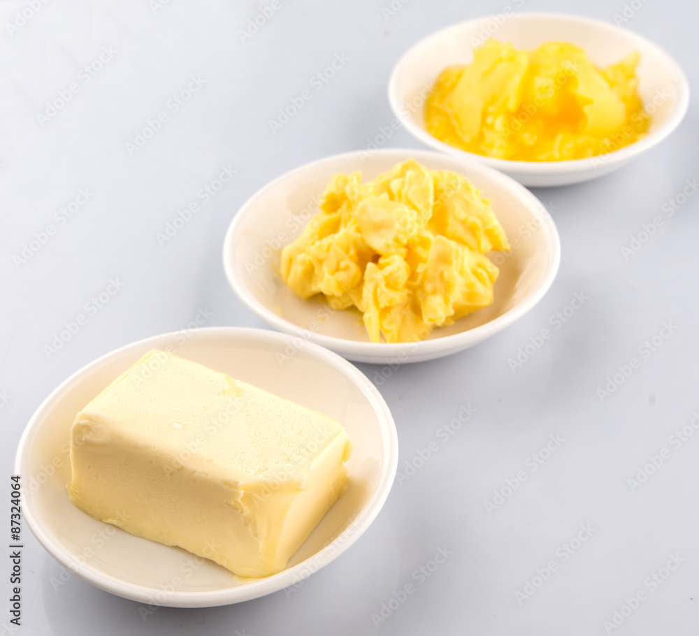 A block of butter, margarine and ghee in white bowls Stock-Foto | Adobe  Stock