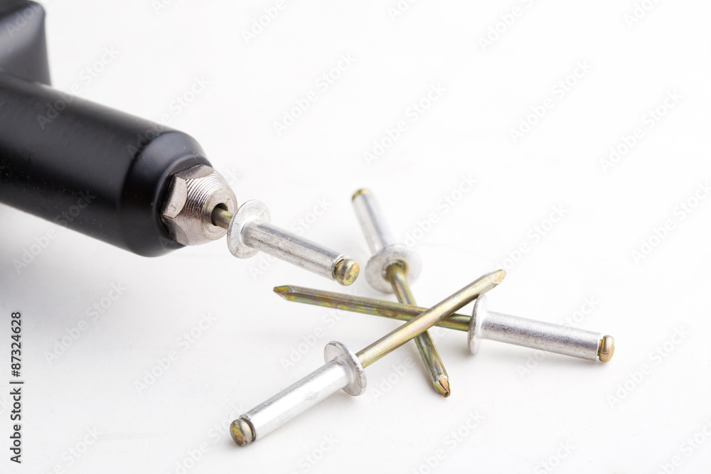 black rivet pliers and rivet on white background black rivet pliers and rivet on white background