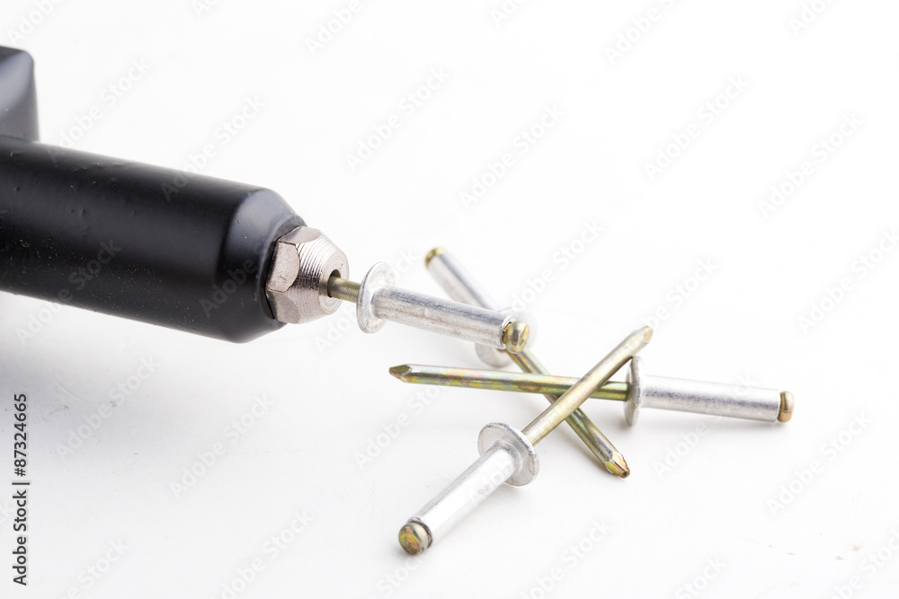 black rivet pliers and rivet on white background black rivet pliers and rivet on white background