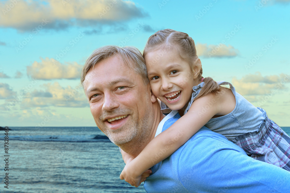Father with daughter against the sea Father with daughter against the sea