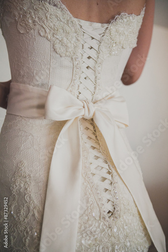 Beautiful luxury lace wedding dress and white bow 