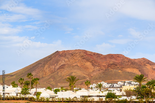White houses in Playa Blanca village with volcano mountain in background, Lanzarote, Canary Islands, Spain
