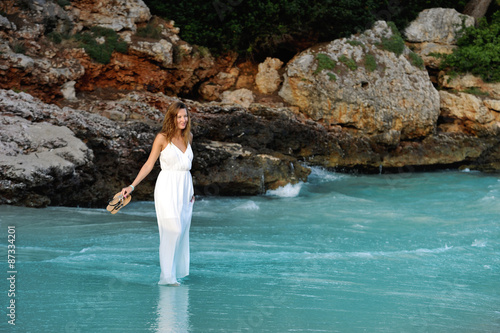 beautiful woman white dress walking on beach enjoying summer holiday  © Wordley Calvo Stock