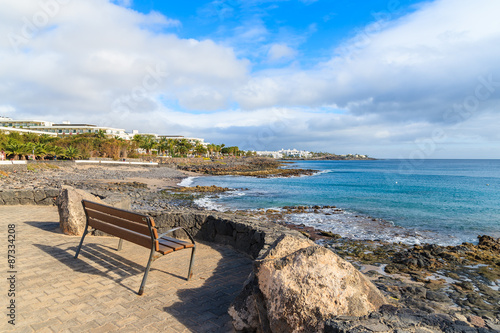 Bench on promenade along ocean coast in Playa Blanca  Lanzarote  Canary Islands  Spain