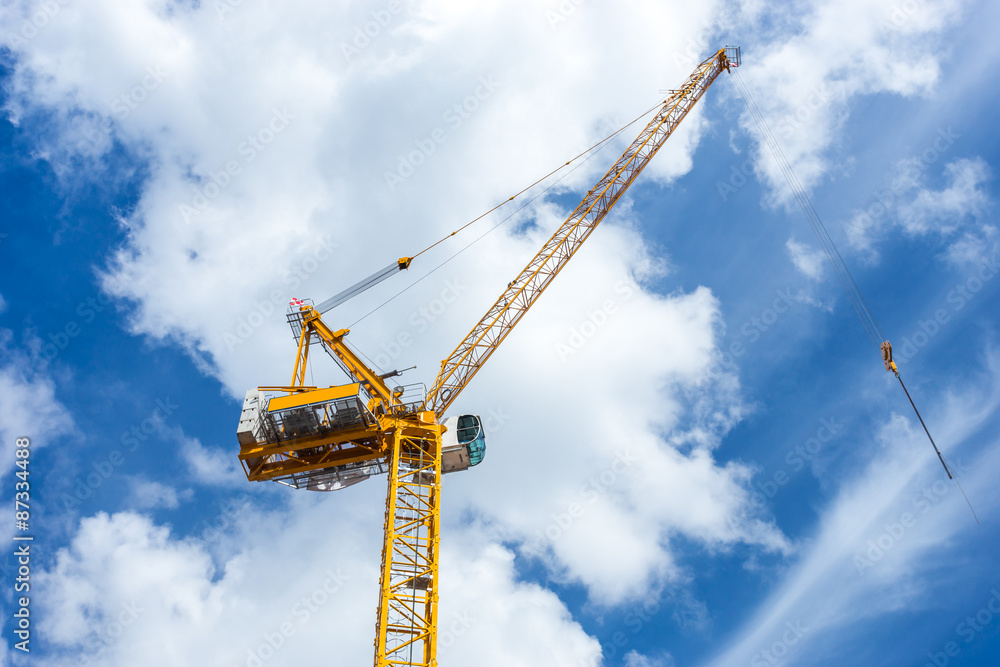 yellow hoisting crane with wonderful blue sky yellow hoisting crane with wonderful blue sky
