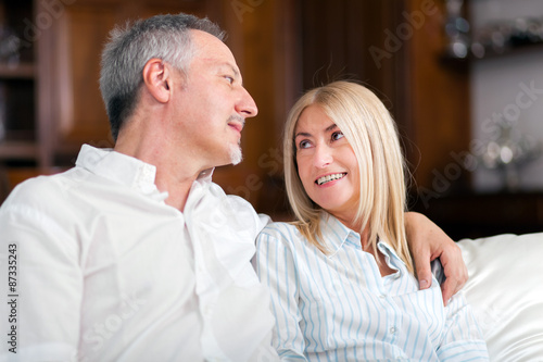  Senior Couple Relaxing On Sofa At Home