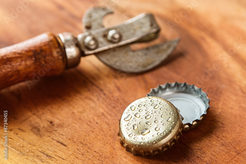 Old opener tool and beer caps