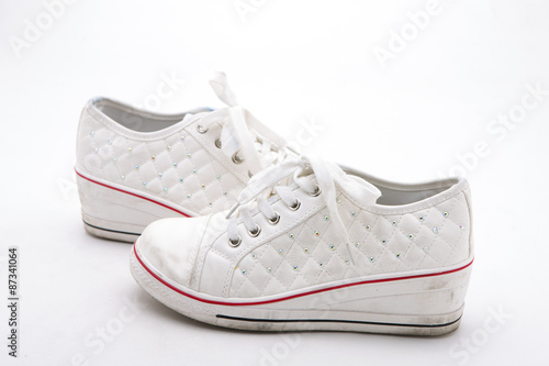 Pair of new white sneakers on white background