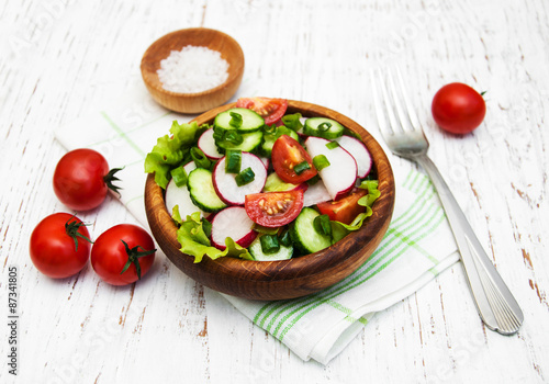 Spring salad with tomato, cucumbers and radish