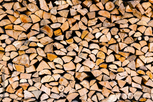 Minced wooden logs stacked in the woodpile