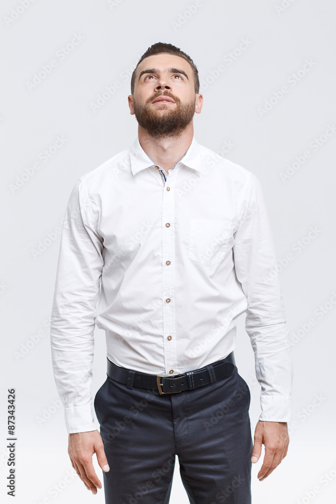 Man with beard standing and looking up Man with beard standing and looking up