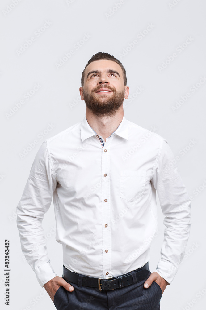 Man with beard standing and looking up Man with beard standing and looking up