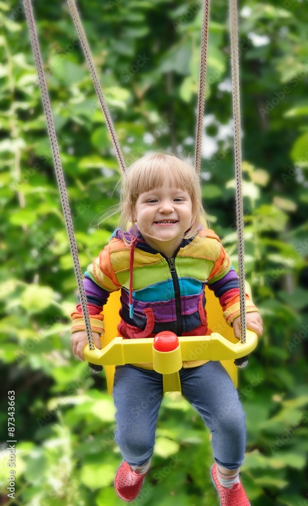 Cute little girl swings. Outdoors scenery. Cute little girl swings. Outdoors scenery.