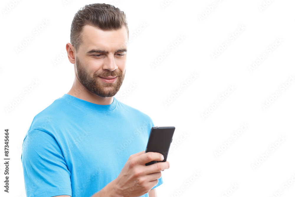 Handsome man with beard holding mobile phone Handsome man with beard holding mobile phone