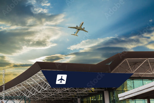 Airport at sunset with an airplane taking off