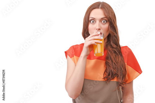 Принти на полотні Pretty red-haired woman drinking juice