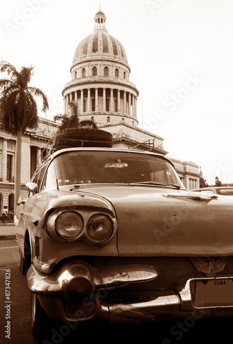 An American classic car in front of the capitol in Havana, Cuba