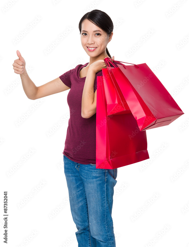 Young woman with shopping bag and thumb up Young woman with shopping bag and thumb up