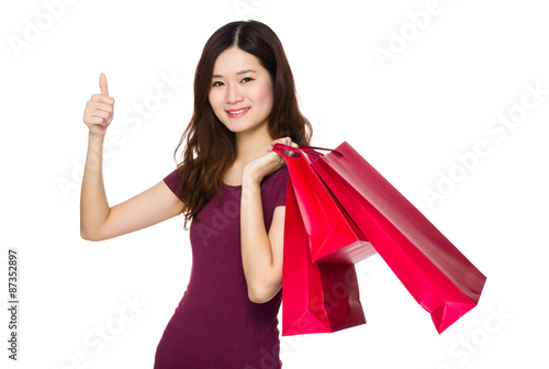 Asian woman with shopping bag and thumb up