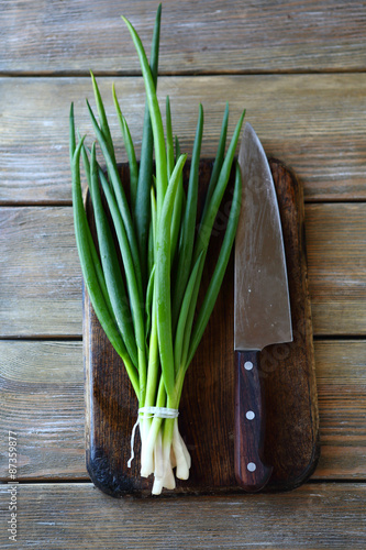 bunch of green onion and knife