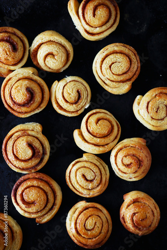 sweet rolls with cinnamon on a baking sheet