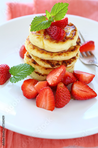 stack of pancakes with fresh strawberries