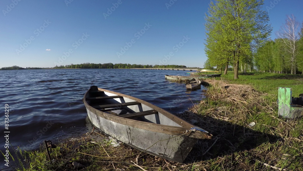 old wooden fishing boats on spring lake water. 4K old wooden fishing boats on spring lake water. 4K