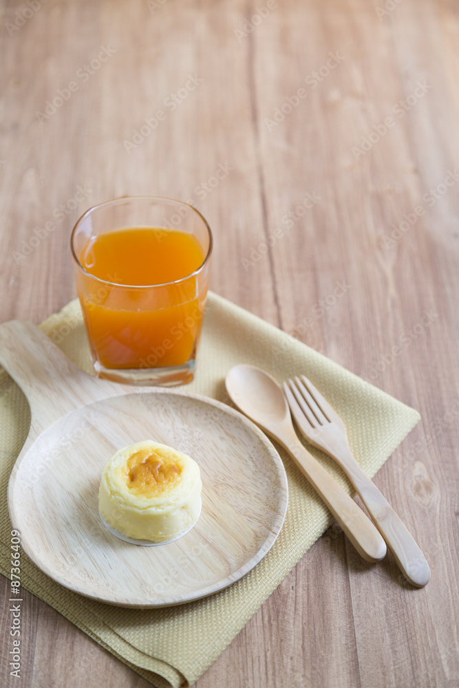 Hokkaido cheesecake with fruit juice with wooden background Hokkaido cheesecake with fruit juice with wooden background