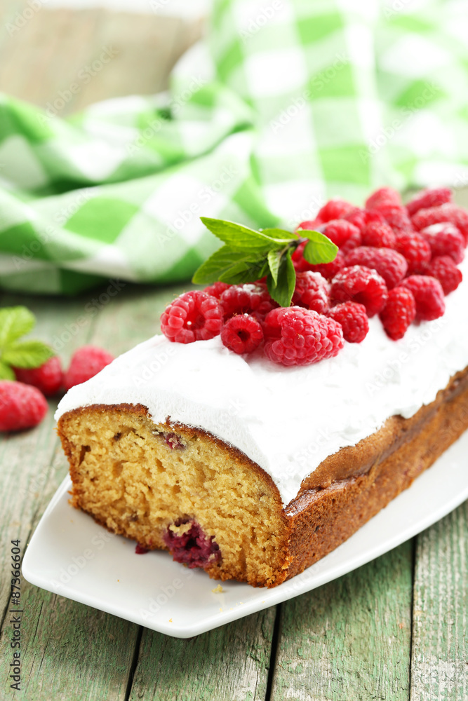 Raspberry cake on plate on green wooden background Raspberry cake on plate on green wooden background
