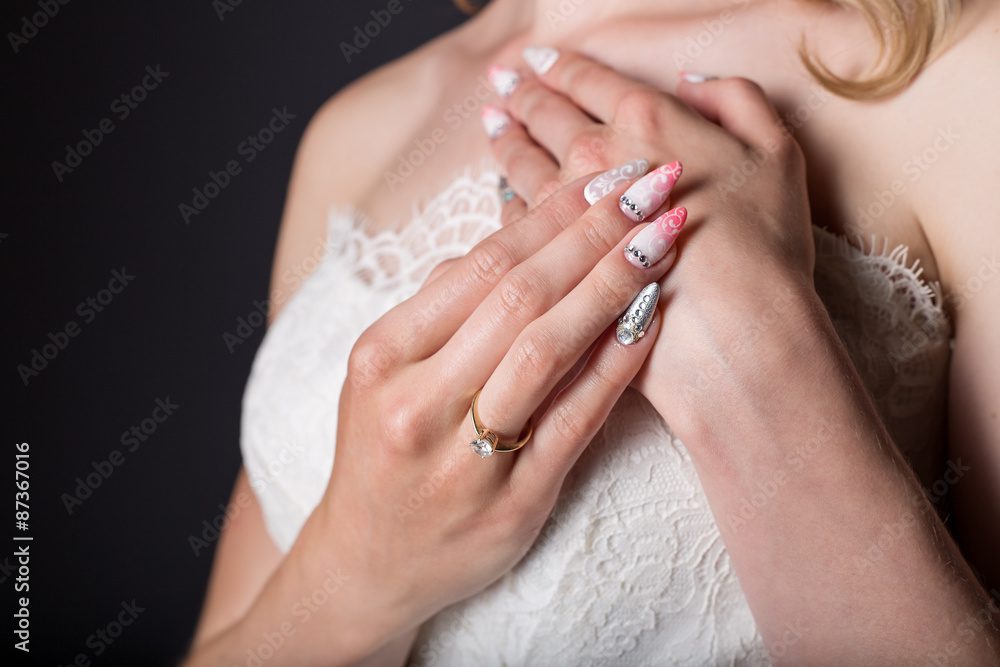 hand beautiful girl bride in white wedding dress with acrylic nails and delicate pattern and rhinestones hand beautiful girl bride in white wedding dress with acrylic nails and delicate pattern and rhinestones