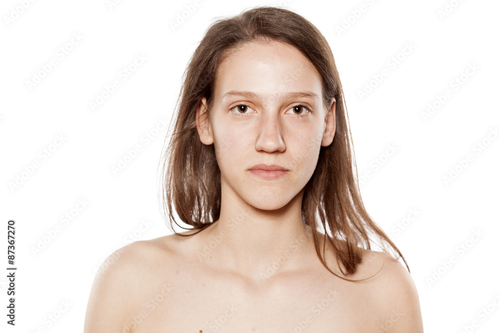 serious young woman without make-up on white background serious young woman without make-up on white background