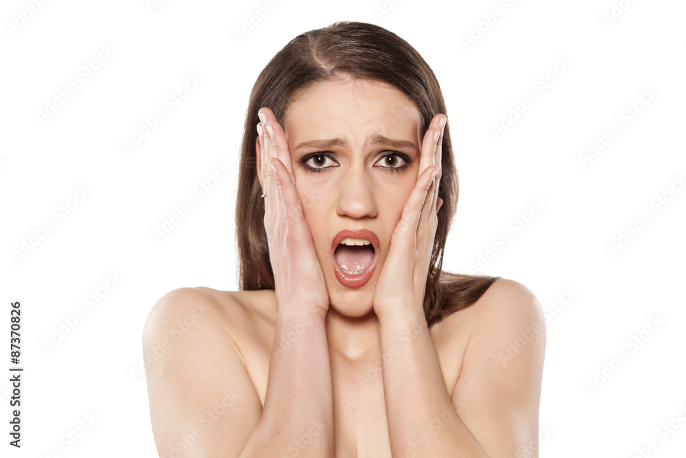 shocked young woman posing on a white background shocked young woman posing on a white background