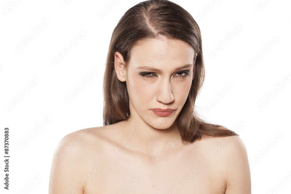 a young beautiful woman suspiciously looking at you a young beautiful woman suspiciously looking at you