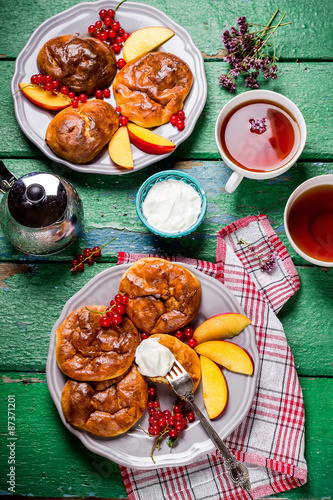 Fritters and tew on wooden table. photo