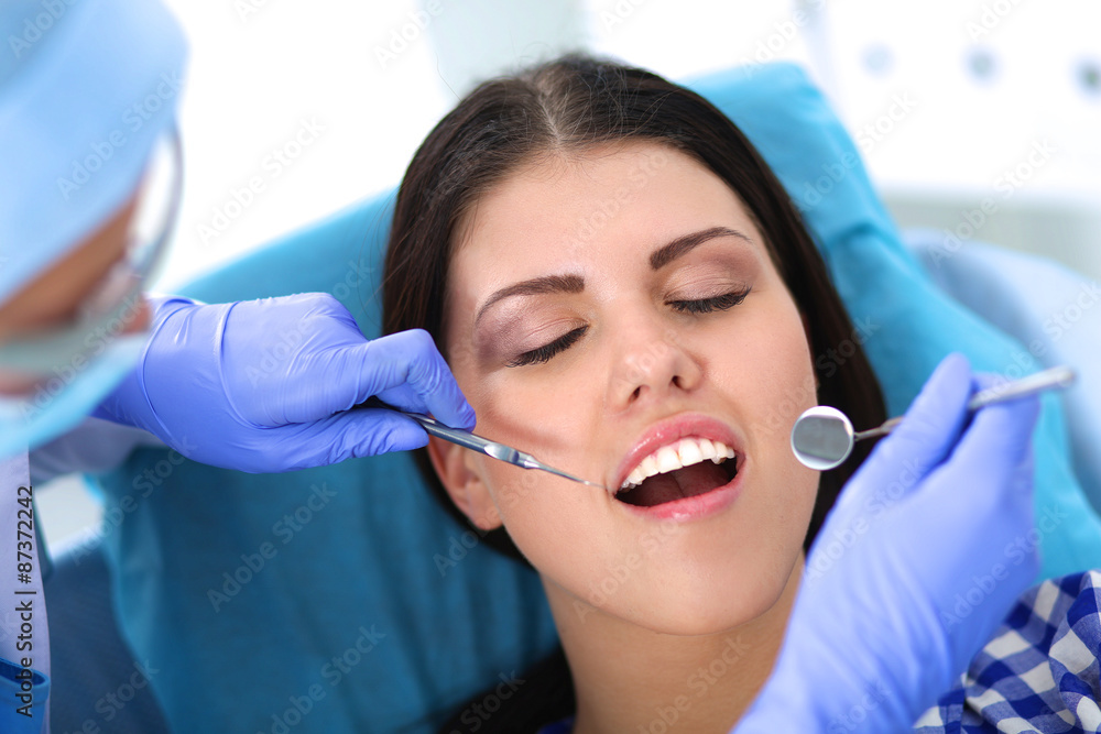 Woman dentist working at her patient's teeth Woman dentist working at her patient's teeth