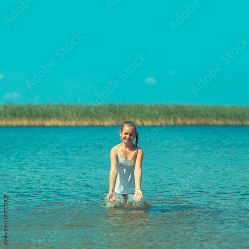 teenager girl cautiously walking on water