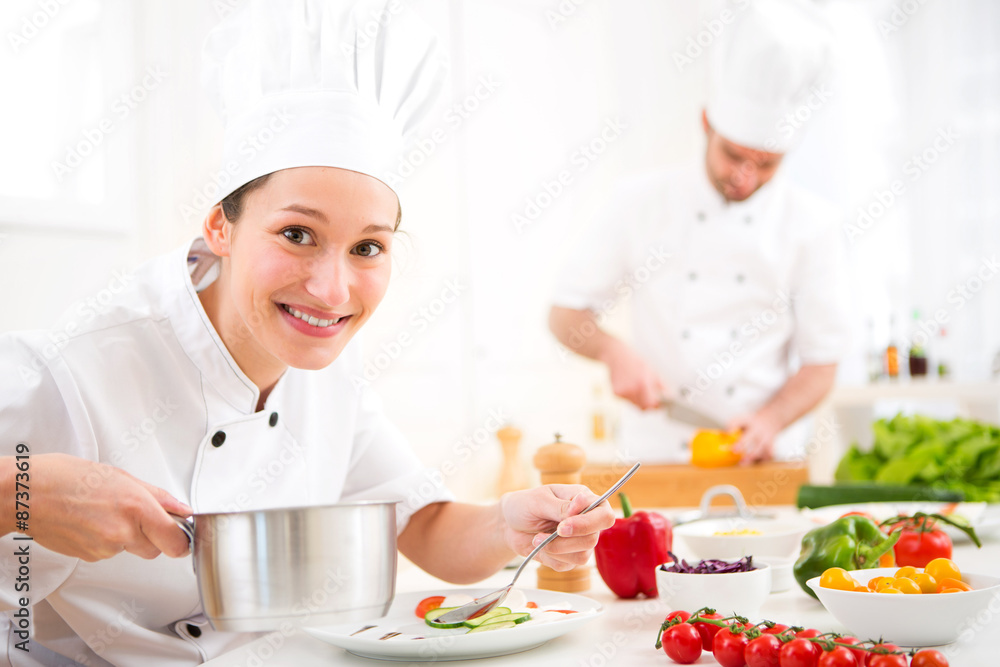 Young attractive professional chef cooking in his kitchen Young attractive professional chef cooking in his kitchen
