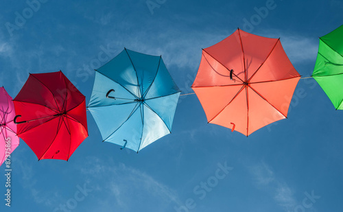 Streets are decorated with colorful umbrellas. 