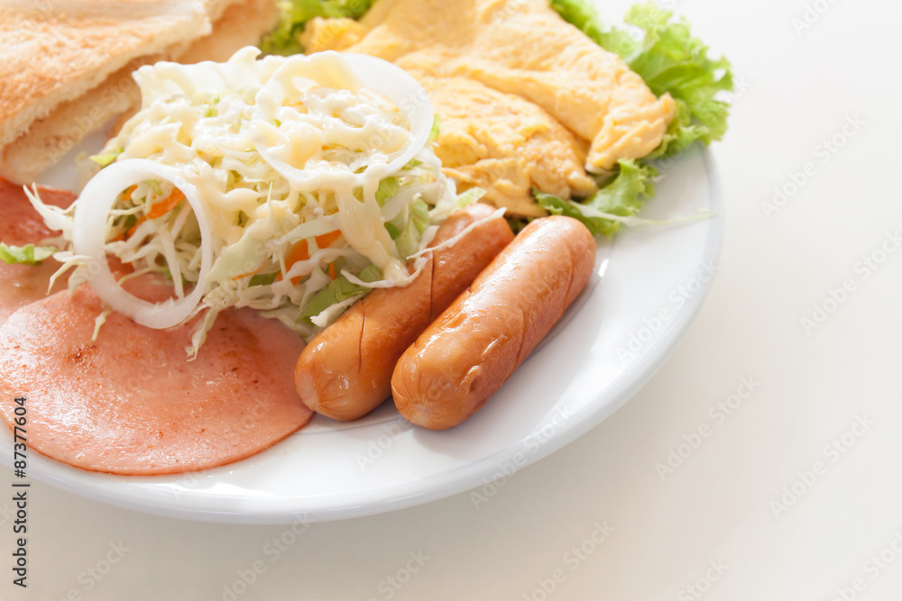 breakfast with bacon, sausage, omelette,salad and toast breakfast with bacon, sausage, omelette,salad and toast