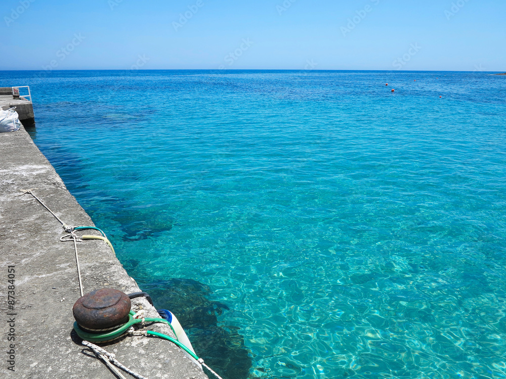 Blue sea view in sunny summer day transparent water at pier
