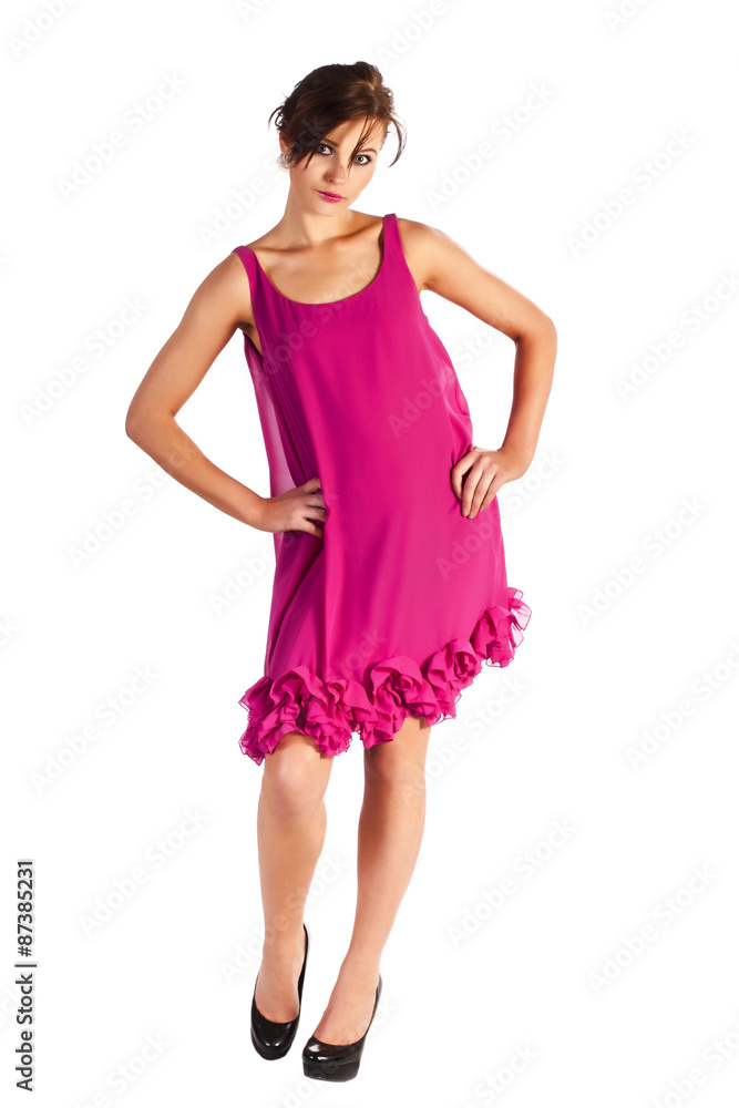Young and sexy woman model in pink dress posing