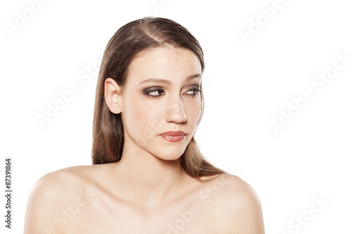 a young beautiful woman looking suspiciously to the side