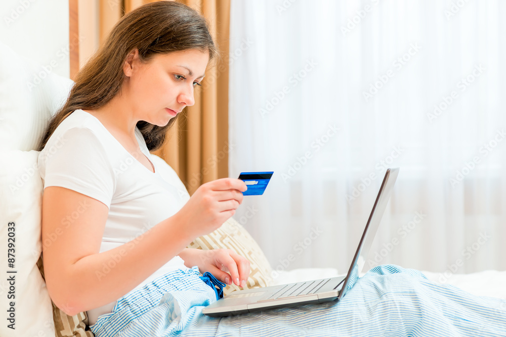 girl makes purchases from the online store paying card girl makes purchases from the online store paying card