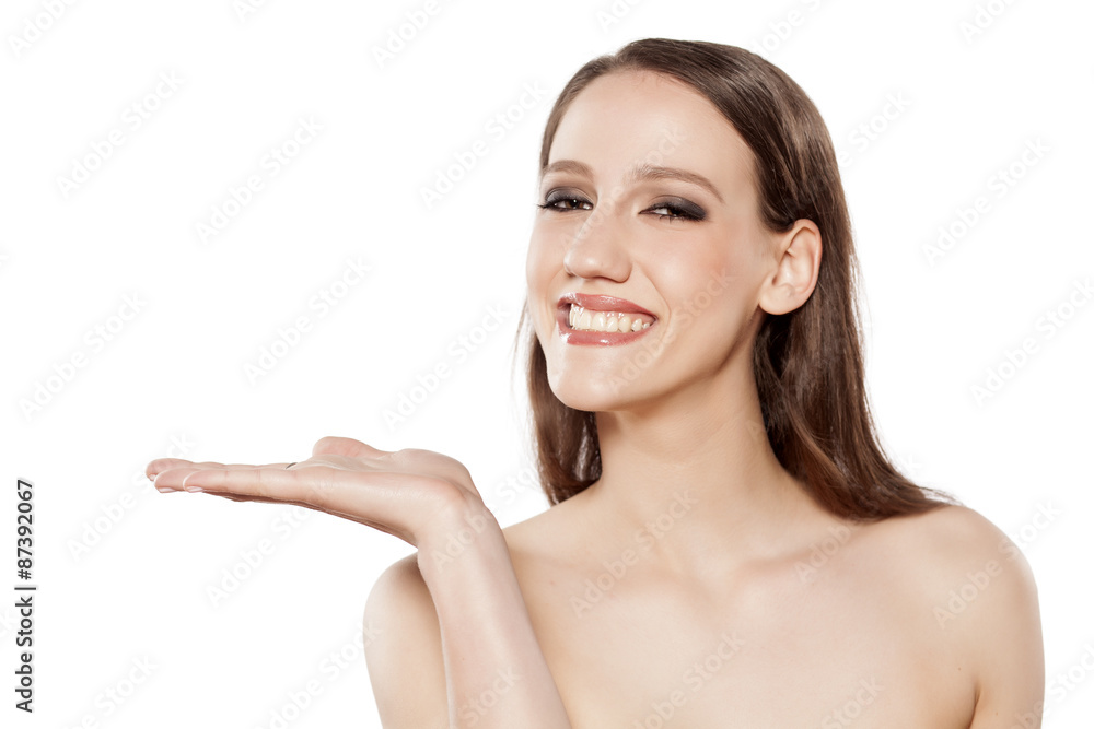 young smiling woman advertises imaginary object young smiling woman advertises imaginary object